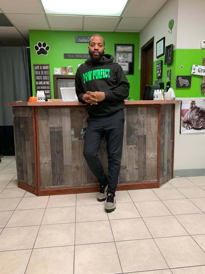 Founder Paul Simon standing at the front desk of PawPurfect Pet Grooming